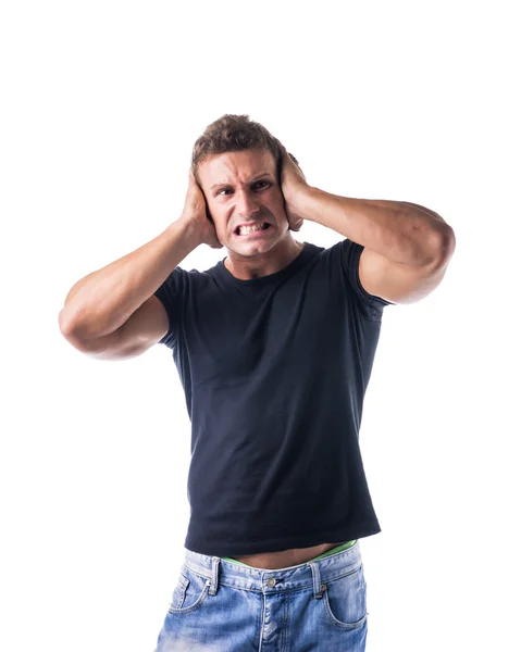 Attractive young man covering his ears, irritated — Stock Photo, Image