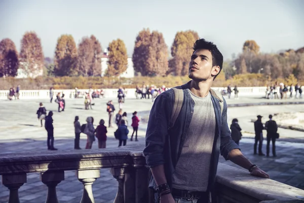 Young Man Holding a Guide Outside Historic Building — Stock Photo, Image