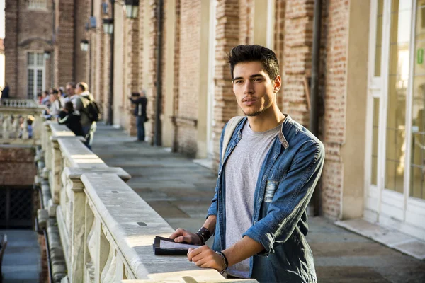 Young Man Holding a Guide Outside Historic Building — Stock Photo, Image