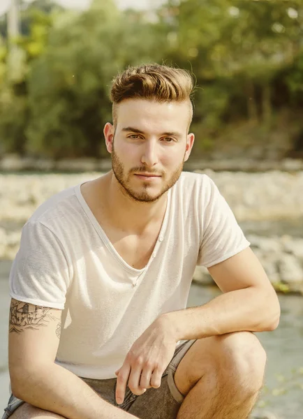 Portrait of handsome young man in white t-shirt outdoors — Stock Photo, Image