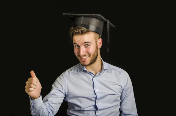 Happy young man graduating, with hat — Stock Photo, Image