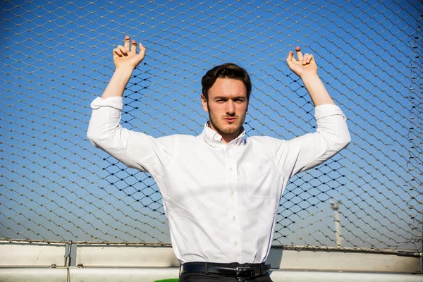 Handsome young man outside wearing white shirt — Stock Photo, Image