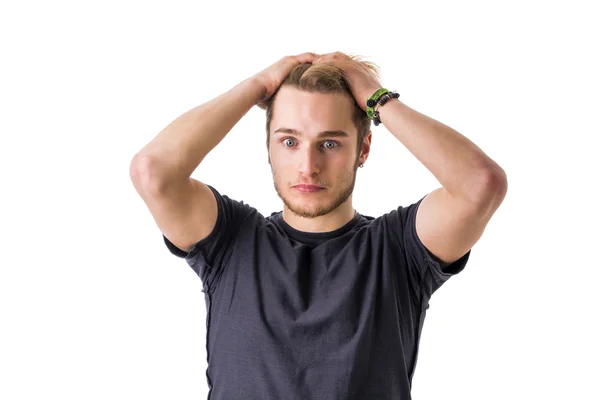 Young bearded man confused and shocked — Stockfoto