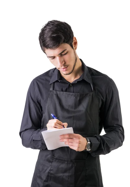 Ung kock eller servitör i svart förkläde isolerad — Stockfoto