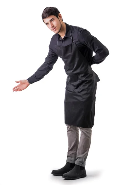 Young chef or waiter wearing black apron isolated — Stock Photo, Image