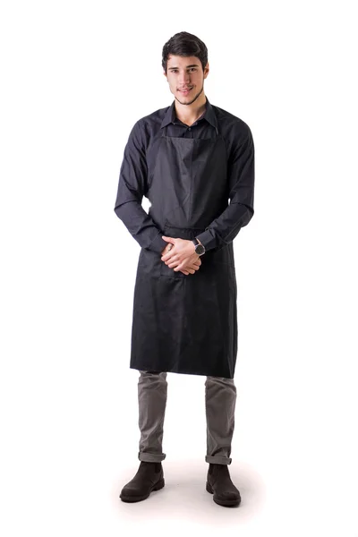 Young chef or waiter wearing black apron isolated — Stock Photo, Image