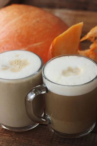 Pumpkin latte on a wooden table macro