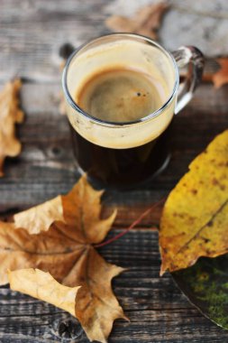 Espresso kahve ve sonbahar yaprakları masada. 