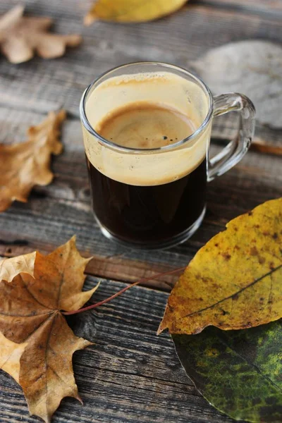 浓缩咖啡和秋天的叶子放在桌上 图库图片