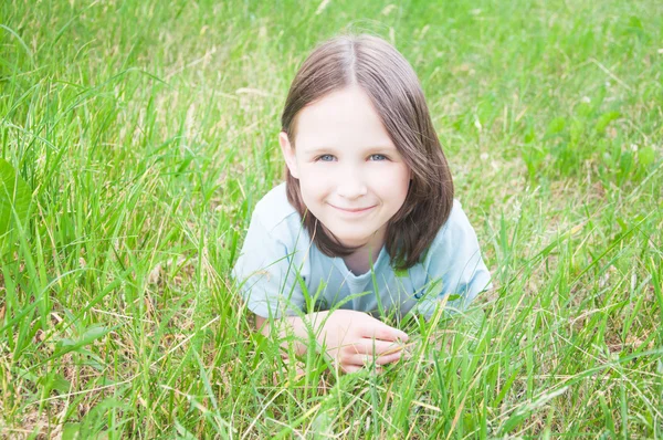 Девочка лежит в траве — стоковое фото
