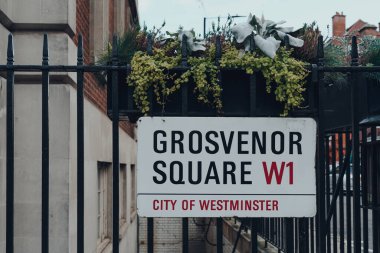 Londra, İngiltere - 5 Aralık 2020: Grosvenor Meydanı, Westminster şehrindeki bir çitin üzerindeki sokak adı tabelası, Londra 'nın merkezi bölgesinin çoğunu kaplayan bir semt..