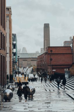 London, UK - November 19, 2020: View of the Peter's Hill, pedestrian walkway leading up from the Thames to St. Paul's Cathedral, Tate Modern and Millennium Bridge on the background.