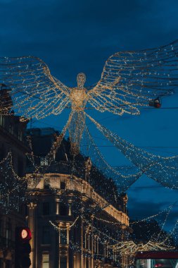 London, UK - November 19, 2020: Angel Christmas lights and decorations on Regent Street, a major shopping street in the West End, London, in the evening.