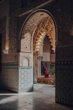 Seville, İspanya - 19 Ocak 2020: Kastilya Kralı Peter için inşa edilmiş bir kraliyet sarayı olan Sevilla Alcazar 'daki Patio de Maidens avlusunun kemerlerinden bakın..