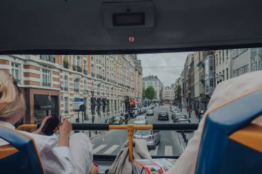 Brussels, Belgium - August 16, 2019: View from top of the tour bus of a street in Brussels, the capital of Belgium and a popular city break destination. Selective focus.