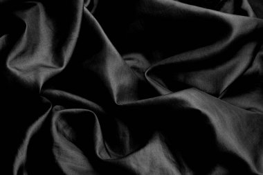 Yumuşak dalgalı desenli, düşük tuşlu siyah soyut bir arka plan. Siyah beyaz tekstil arka planı. Siyah minimal arkaplan. 