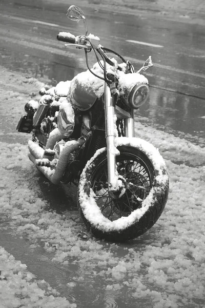 Tbilisi, Georgia. February 18, 2021. Black and white image of a retro style motorcycle covered with snow