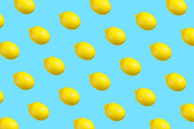 Colorful repetitive pattern made of isolated lemons on bright aqua blue background