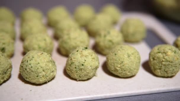 Falafel - balls of chickpea, herbs and vegetables are ready to be roasted in oil. — Stock Video
