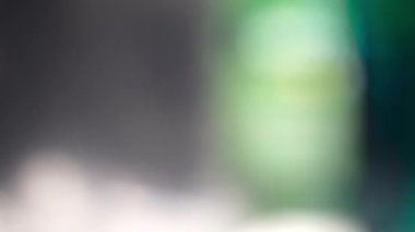 Döngülü renkli arka plan. Sürrealist ışık geçişleri. Koyu arkaplanda parlayan ışık huzmeleri. 