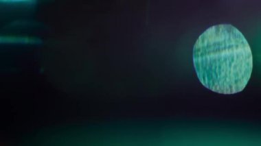 Multi-colored light leaks, beams passing through glass surface. 