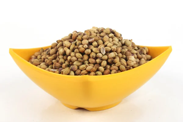 Coriander seeds in a yellow melamine bowl isolated on white background — Stock Photo, Image