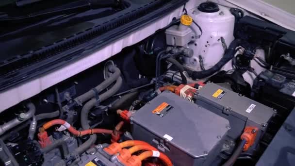 Close-up gedetailleerd overzicht van elektrische auto motor in de fabriek. Elektrische apparatuur van de een Japanse vervaardigd tonen in een auto showroom. Diagnostiek en reparatie van originele onderdelen. De planeet redden — Stockvideo