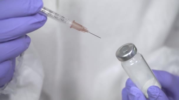 近距离医生 双手戴手套 拿着注射器和带疫苗的安培剂 准备注射 接种疫苗 医疗设备 科学发现新药 保健概念4K — 图库视频影像