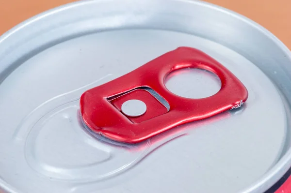 Close-up on red soda can opener.