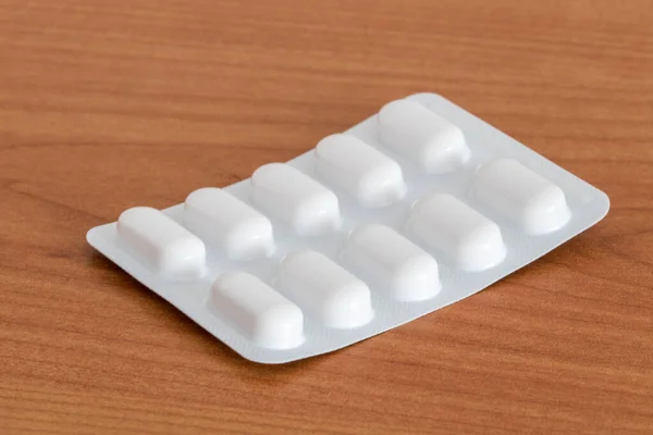Ten Tablets Blister Pack Wooden Table — Stock Photo, Image