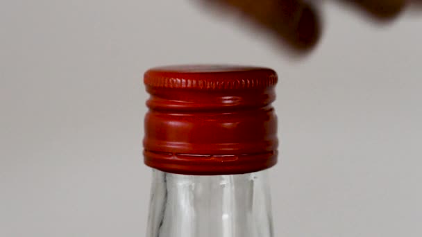 Unscrews Red Metal Cap Glass Bottle — Vídeo de Stock