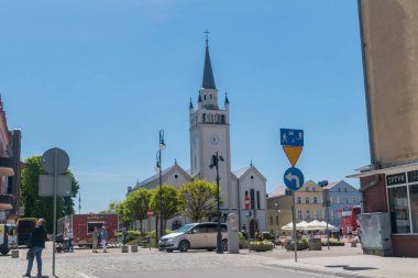Bytow, Poland - May 31, 2021: View of the entrance to the market square and the Church of St. Catherine of Alexandria and St. John the Baptist in Bytow.