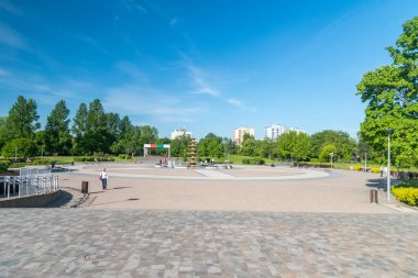 Pila, Poland - May 31, 2021: A square with a fountain in the Park on the Island.