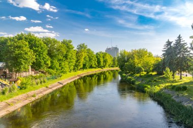 Pila, Poland - May 31, 2021: Beautiful summer view on Gwda river with hotel Gromada in background.