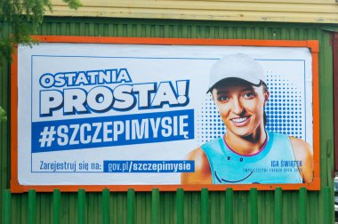 Szczyrk, Poland - June 6, 2021: Billboard with Iga Swiatek that's persuading the public to take the vaccine, in terms of Covid-19 (Coronavirus). clipart