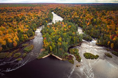Tahquamenon Nehri 'nin aşağısındaki şelale çağlayanlarının güzel antenleri her zaman yeşillerle çevrili ve yaprakları sarı, yeşil, kırmızı ve turuncu yapraklı yapraklarla doludur..