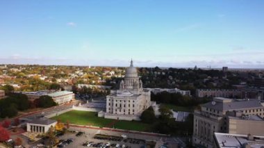 Providence, RI - 21 Ekim 2020: Büyük kubbesi ve beyaz dış yüzeyi ile Rhode Island State House şehir merkezinde sonbahar renkli ağaçlarla çevrili tepenin üzerinde yer almaktadır..