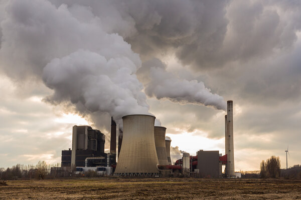 Coal-fired power plant with cloudy sky