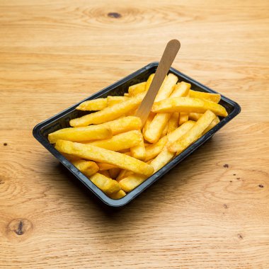 Belgian fries in a black shell clipart