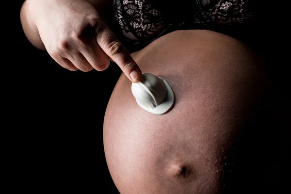 Belly of pregnant woman with worker helmet — Stock Photo, Image