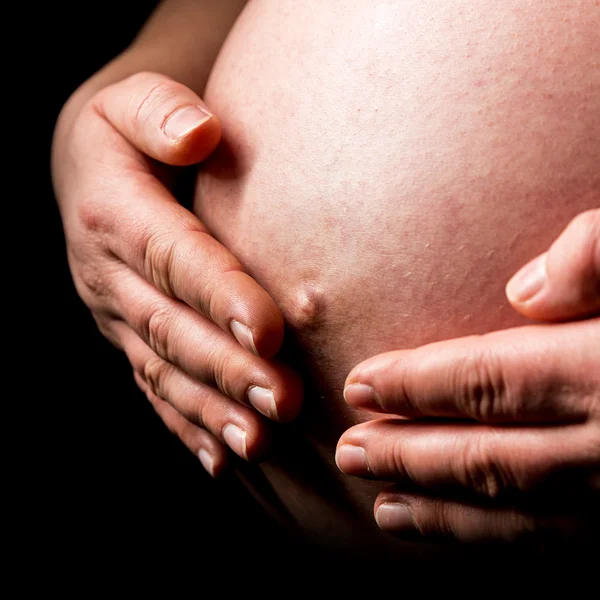 Belly of pregnant woman with hands close-up — Stock Photo, Image