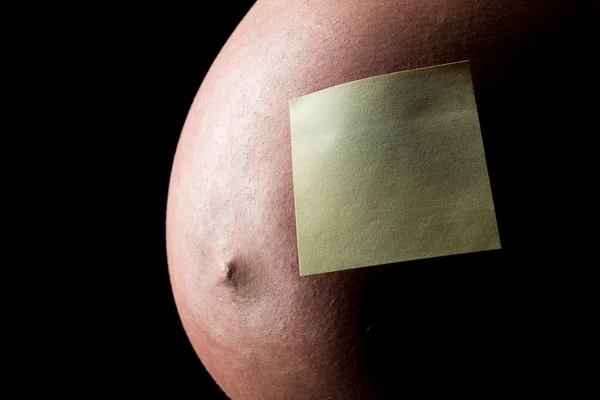 Pregnant woman belly with Sticky Note — Stock Photo, Image