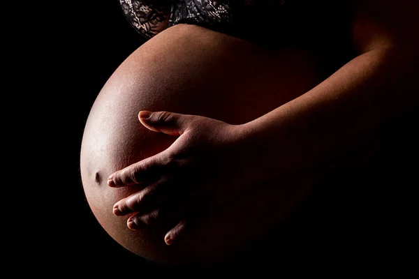 Pregnant woman caressing her belly — Stock Photo, Image