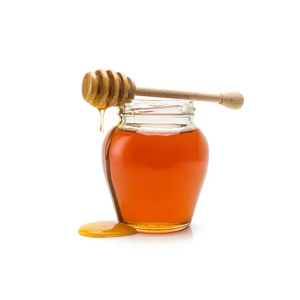 Glass jar of honey and stick Stock Picture