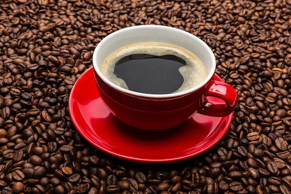 Coffee cup with roasted beans — Stock Photo, Image