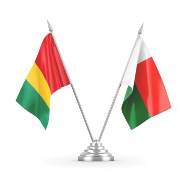 Madagaskar ve Gine masa bayrakları beyaz 3D görüntüleme üzerinde izole edildi