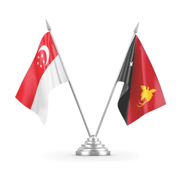 Papua Nya Guinea och Singapore bordsflaggor isolerade på vit 3D-rendering — Stockfoto