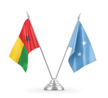 Mikronezya ve Gine-Bissau masa bayrakları beyaz 3D görüntüleme üzerinde izole