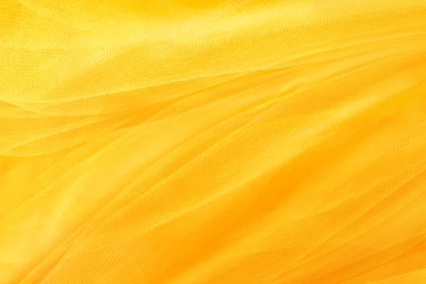 Yellow background, textiles and yellow mesh — Stock Photo, Image
