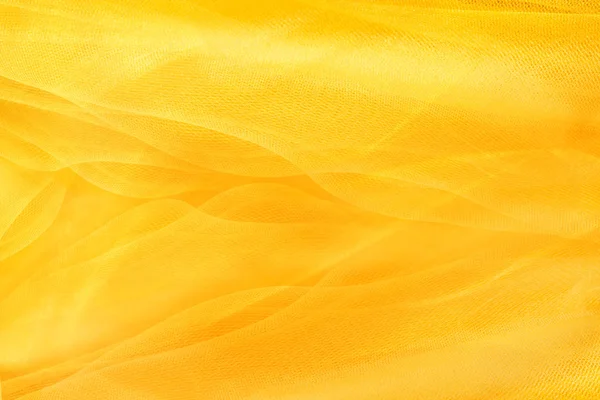 Yellow background, textiles and yellow mesh — Stock Photo, Image